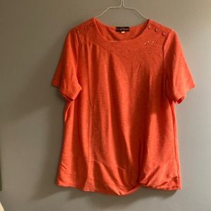 Claire France orange with white smears across the blouse